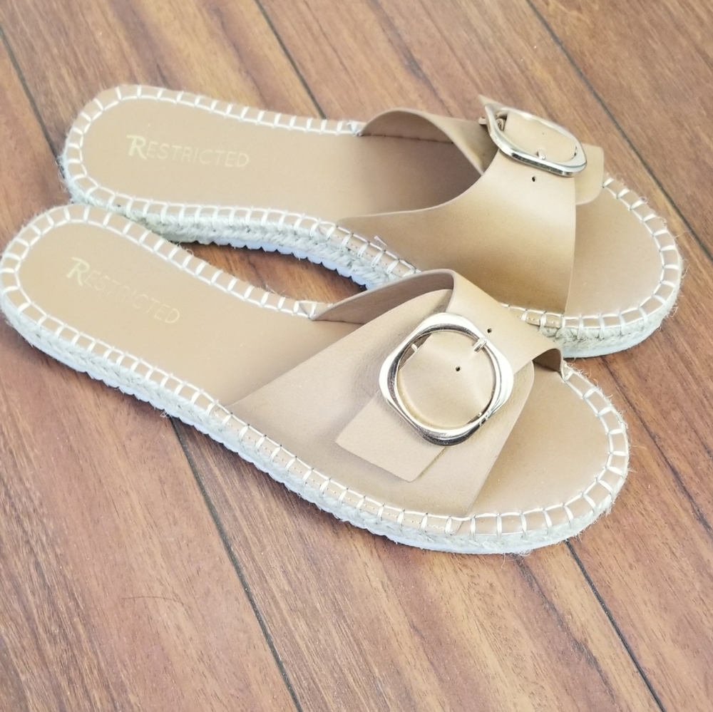 Restricted slip sandals with gold buckle accents.